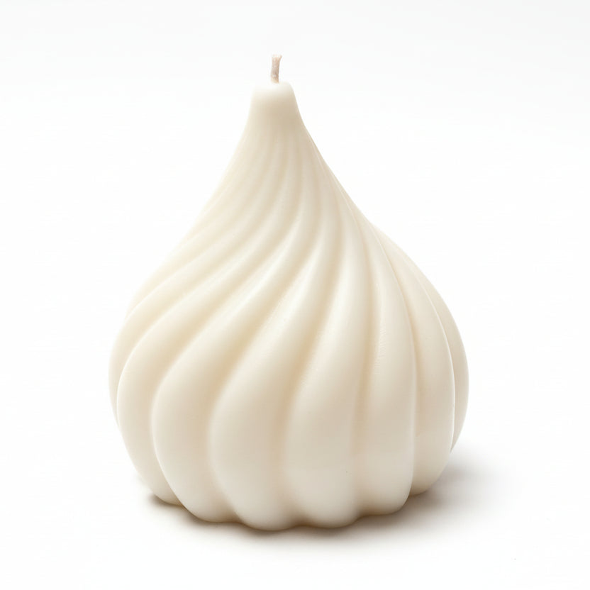 White sculptural candle with a unique swirled geometric design on a white background