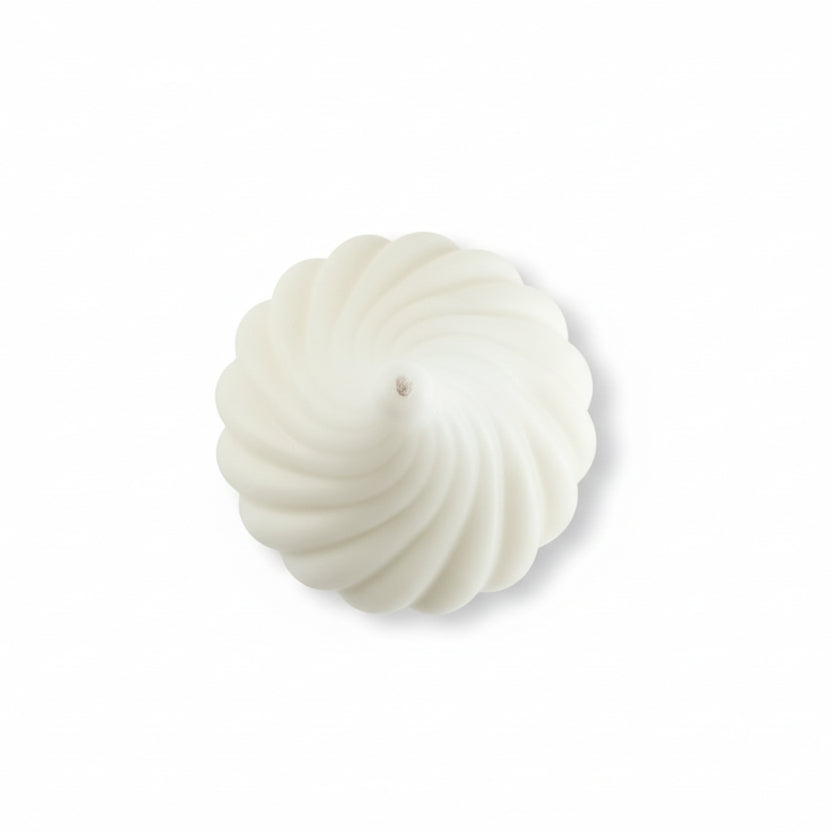 White sculptural geometric swirl candle made from natural wax, top view on white background