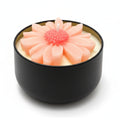 Flower-shaped sculptural candle in a black reusable container, natural wax, decorative home decor