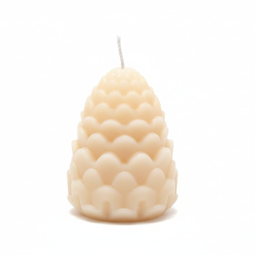 Natural wax sculptural candle with geometric scalloped design on white background