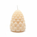Natural wax sculptural candle with geometric scalloped design on white background