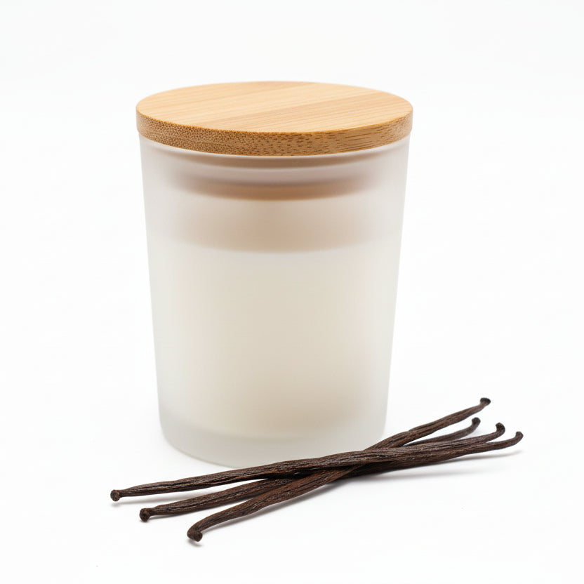 Vanilla scented candle in frosted glass jar with bamboo lid and vanilla beans