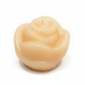 Natural wax rose-shaped sculptural candle on white background