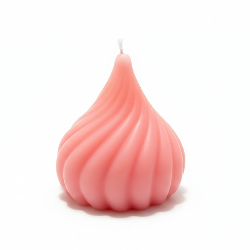 Pink sculptural swirl candle with geometric design on white background