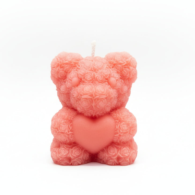 Pink sculptural bear candle with floral texture holding a heart, natural wax, gift decor