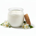 Coconut wax candle in glass jar with cork lid and jasmine flowers on white background.