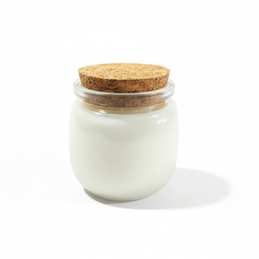 Natural coconut wax candle in a clear glass jar with a cork lid