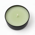 Lemongrass coconut scented candle in a black round container on white background