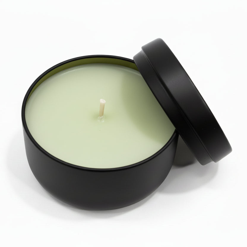 Lemongrass coconut wax candle in matte black reusable tin with lid, on white background
